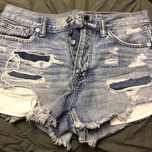 Distressed multiple button jean short